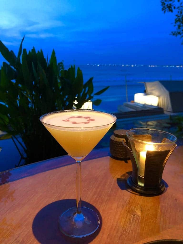 Orange Liquid in Clear Martini Glass on Brown Wooden Surface