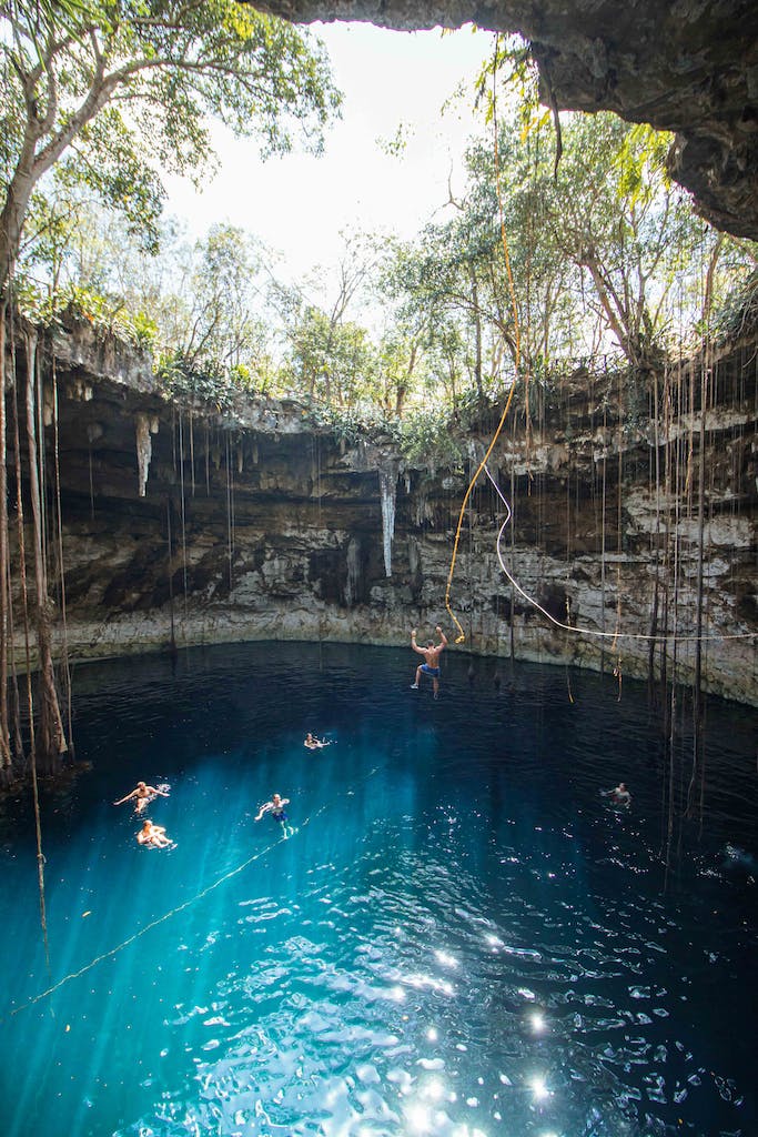 People Swimming in Cave Lake