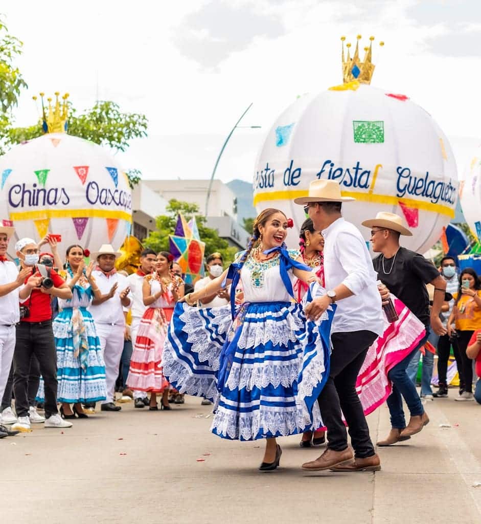 A group of people dressed in colorful costumes walking down a street