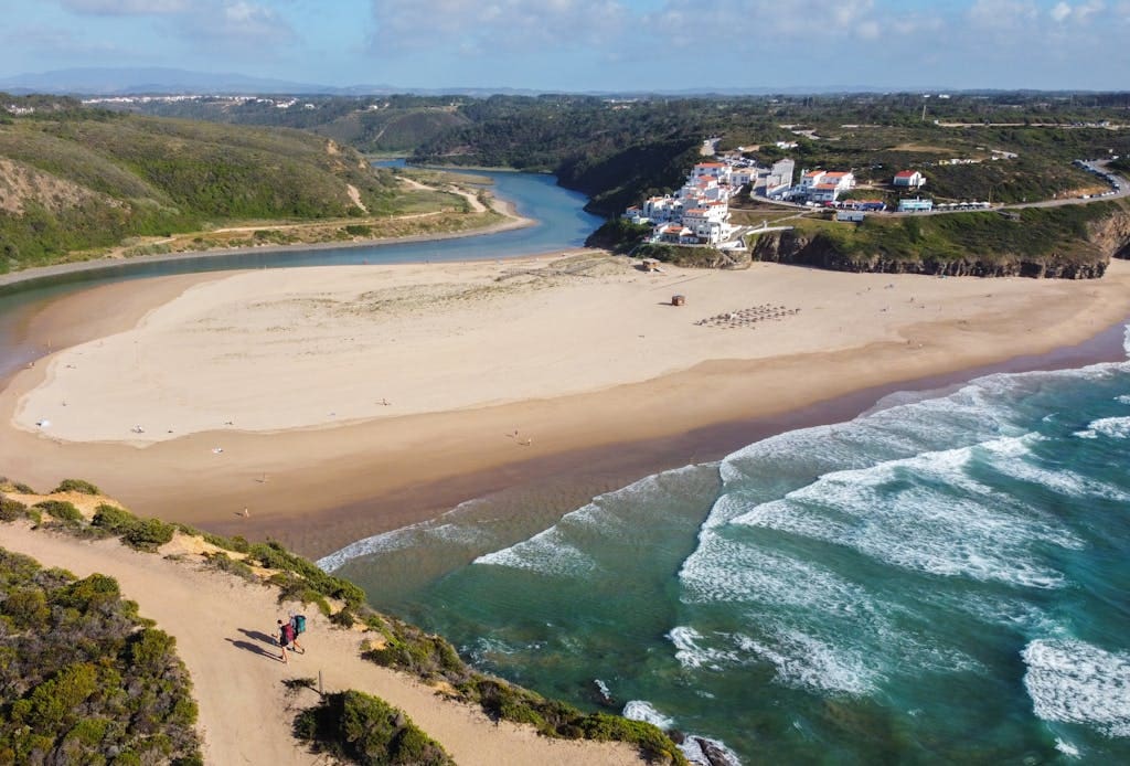 A beach with a sandy shore and a river