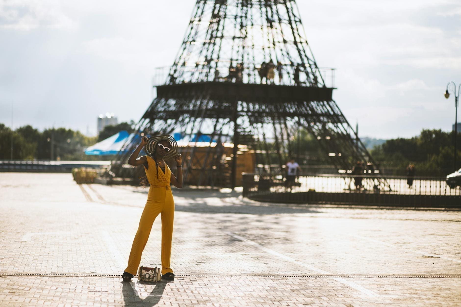 woman wearing orange jumpsuit while holding hat