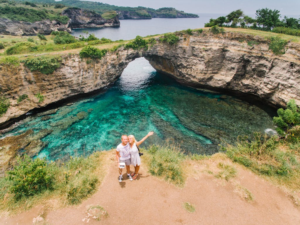 Drone Shot of a Man and a Woman Posing Near a Lagoon