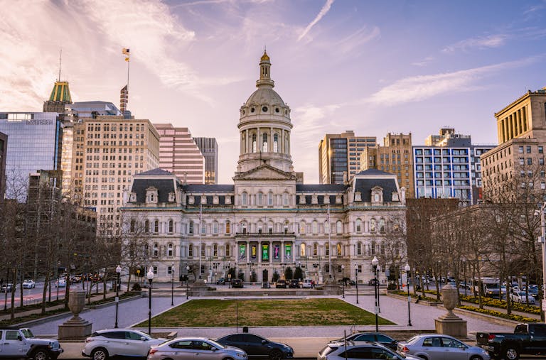 Majestic view of Baltimore City Hall with the city skyline during daytime.