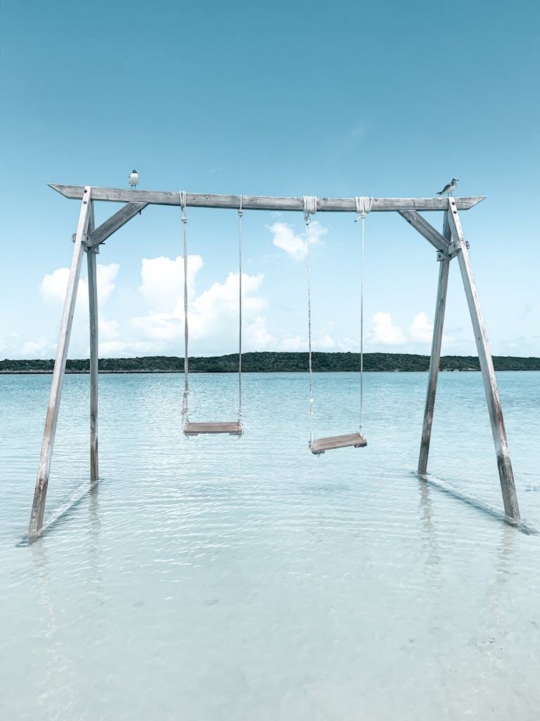 Swing set in shallow, tranquil waters on a sunny day in Exuma, Bahamas.