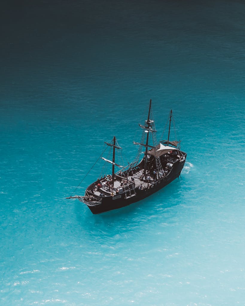 A picturesque view of a pirate ship on a vibrant turquoise ocean near Waimea, Hawaii.